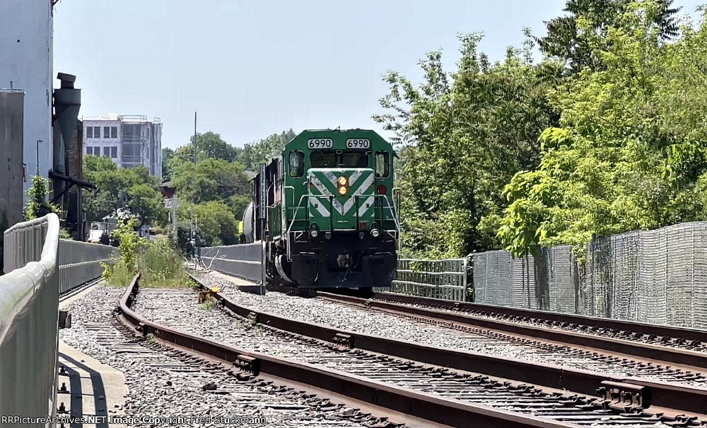 WE 6990 passes the former Star of the West Milling Co. siding.